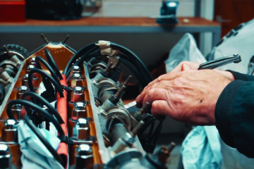 A teacher works on a engine at the Heritage Skills Academy