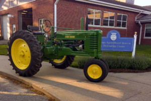 A restored John Deer tractor in front the Wagamo regional high school.