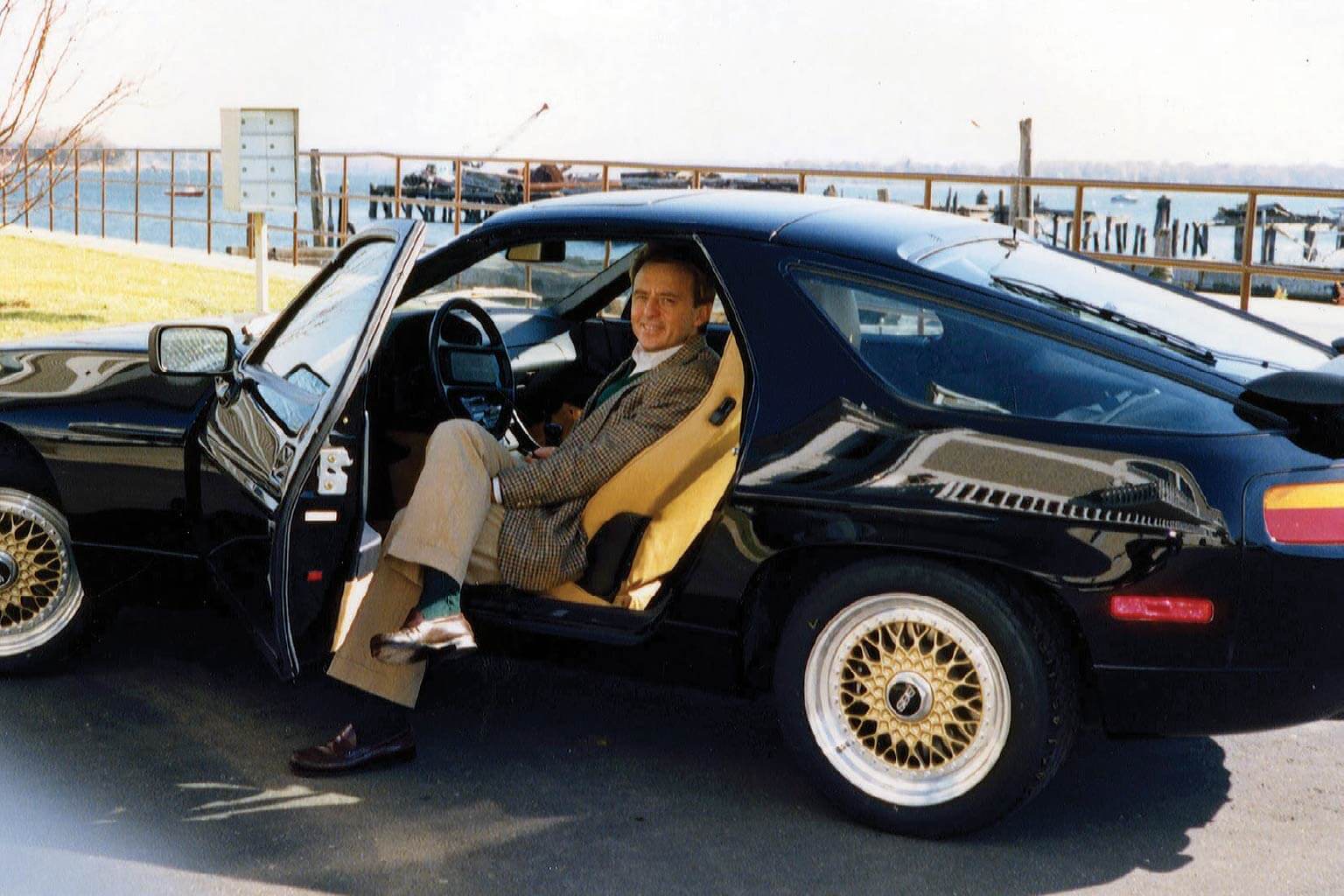 Man sitting in a car with the door open