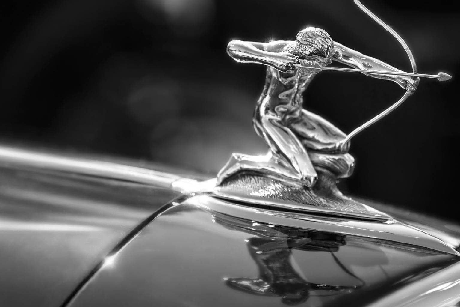 A car statue showing a person shooting a bow and arrow